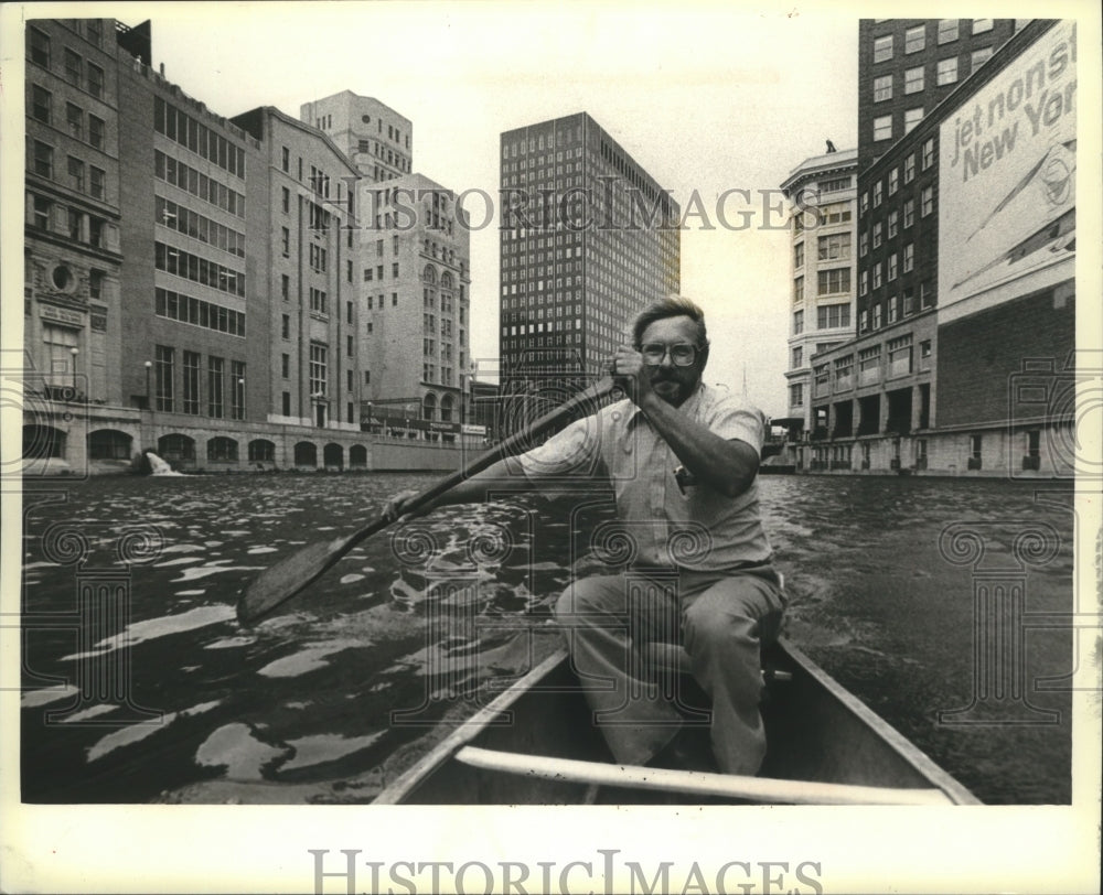 1979 Ron Leys paddles along Downtown Milwaukee - Historic Images