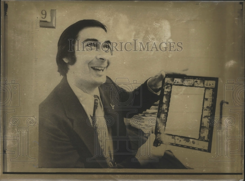 1974 Man Smiles While Holding a Picture Frame With Film Stills-Historic Images