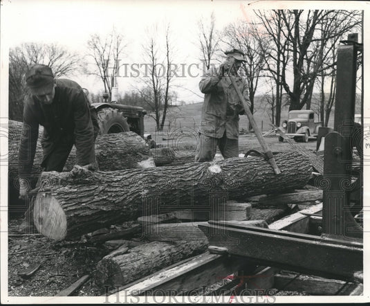 1957 Press Photo Leslie Schwartz and Boegel roll log , Wisconsin - mjb09034 - Historic Images