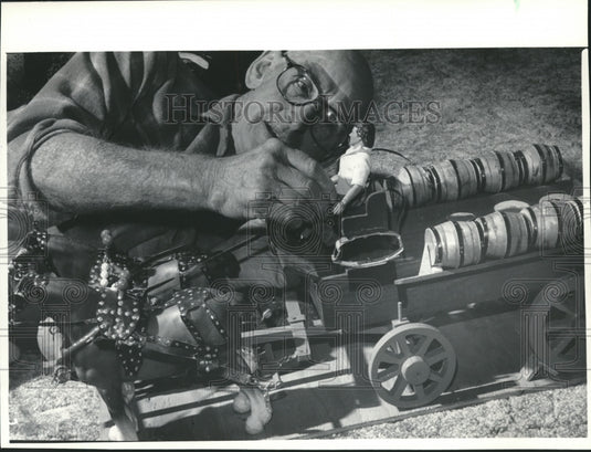 Paul Lucey from Milwaukee, places driver on beer wagon he carved-Historic Images