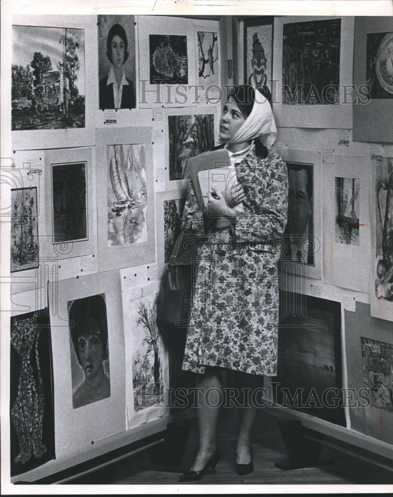 1963 Ann Grade views the artwork of many young Wisconsin students-Historic Images