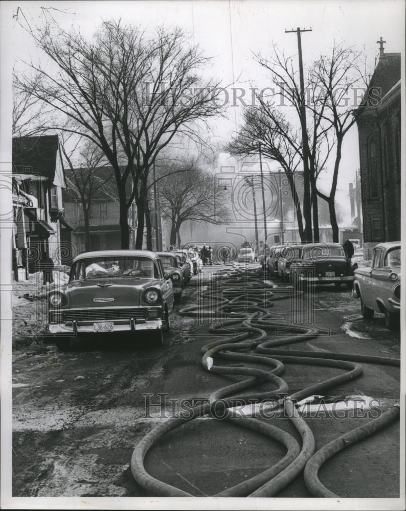 1959 Press Photo Fire Hoses laying in Street with Cars in Milwaukee, Wisconsin - Historic Images