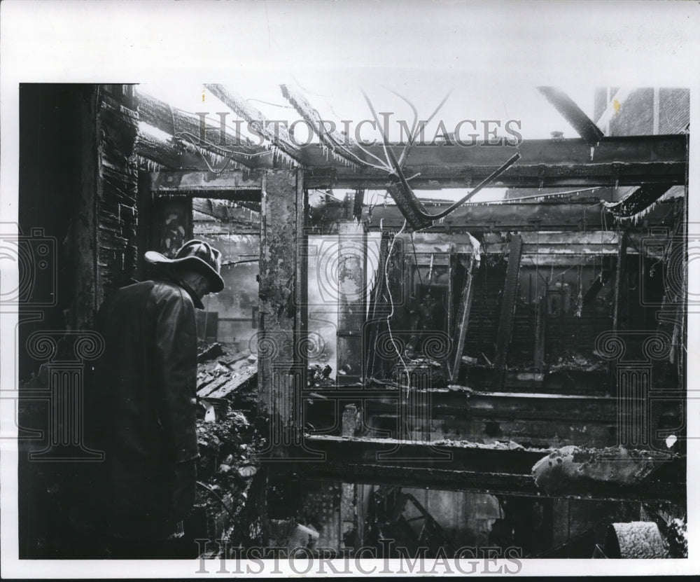 1960 Firefighter examines remains of five-alarm fire in Milwaukee-Historic Images