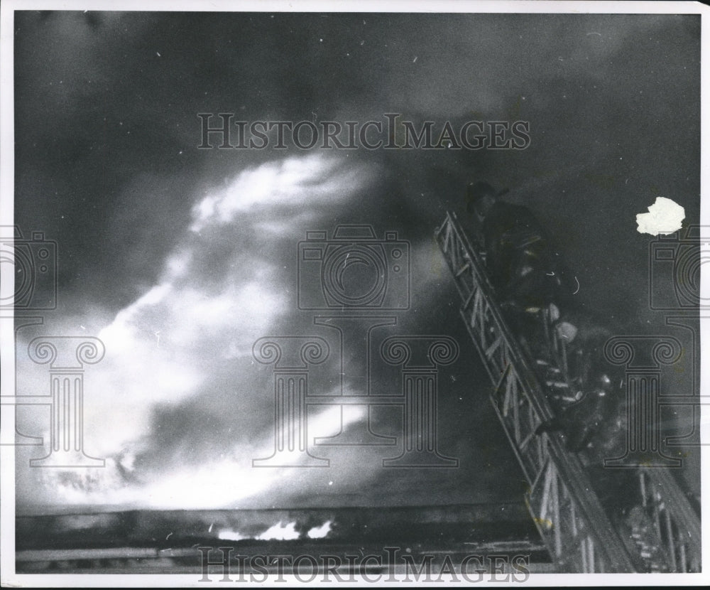 1959 Press Photo Two Milwaukee firemen inch up a ladder trying to quell blaze - Historic Images