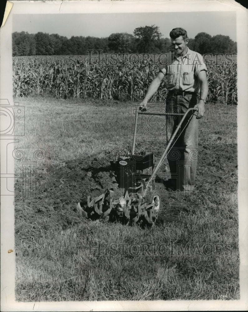 1958 Press Photo A vegetable gardener uses rotary tiller to prepare the soil.-Historic Images