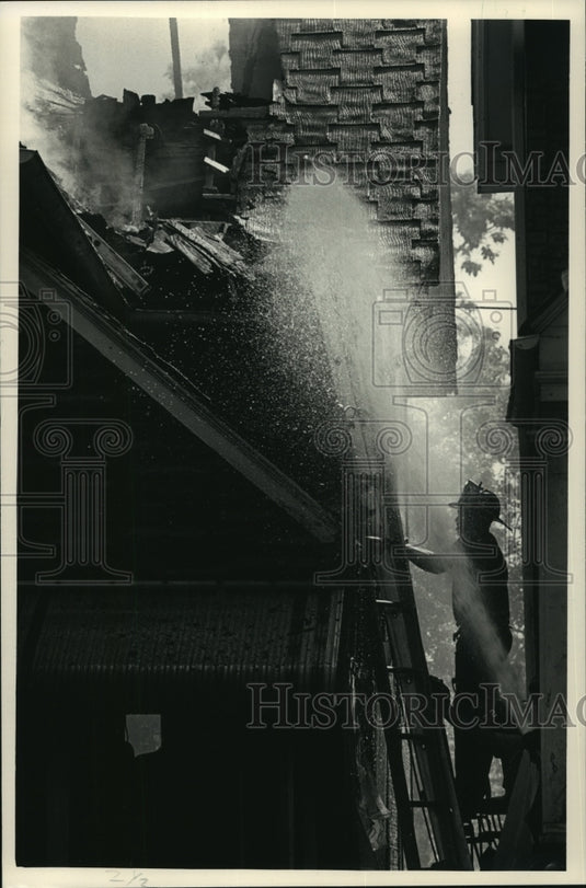 1987 Press Photo Firefighters hose down the roof of a home on Fond du Lac Ave. - Historic Images