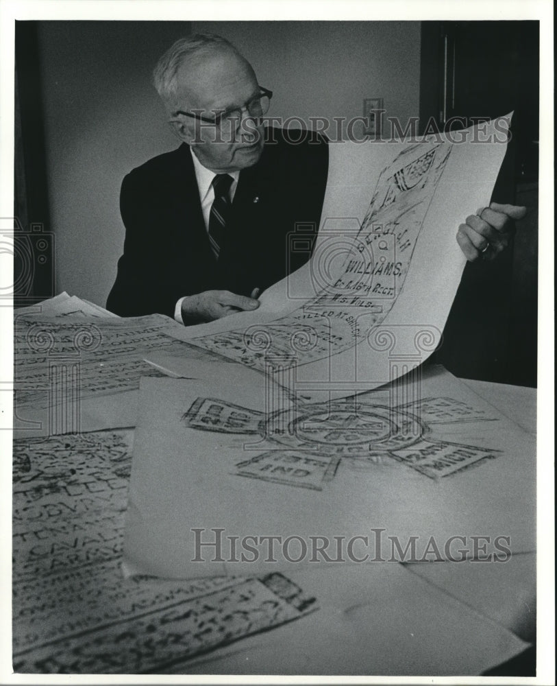 1984 Press Photo F. Winston Luck, holds a rubbing of a gravestone, Milwaukee. - Historic Images