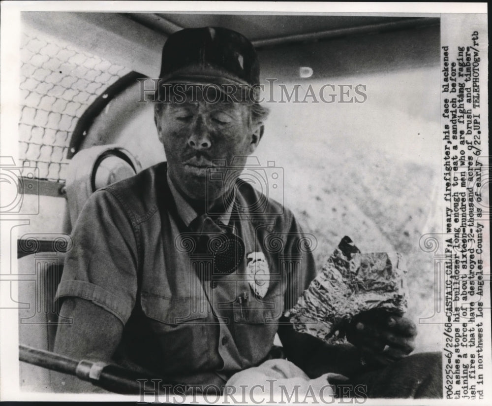 1968 Press Photo Firefighter with Blackened Face eats Sandwich in Bulldozer-Historic Images
