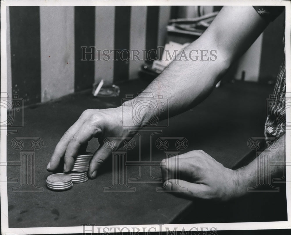 1954 Press Photo Man Counting and dispensing Sliver Coins, Gambling - mjb20401 - Historic Images