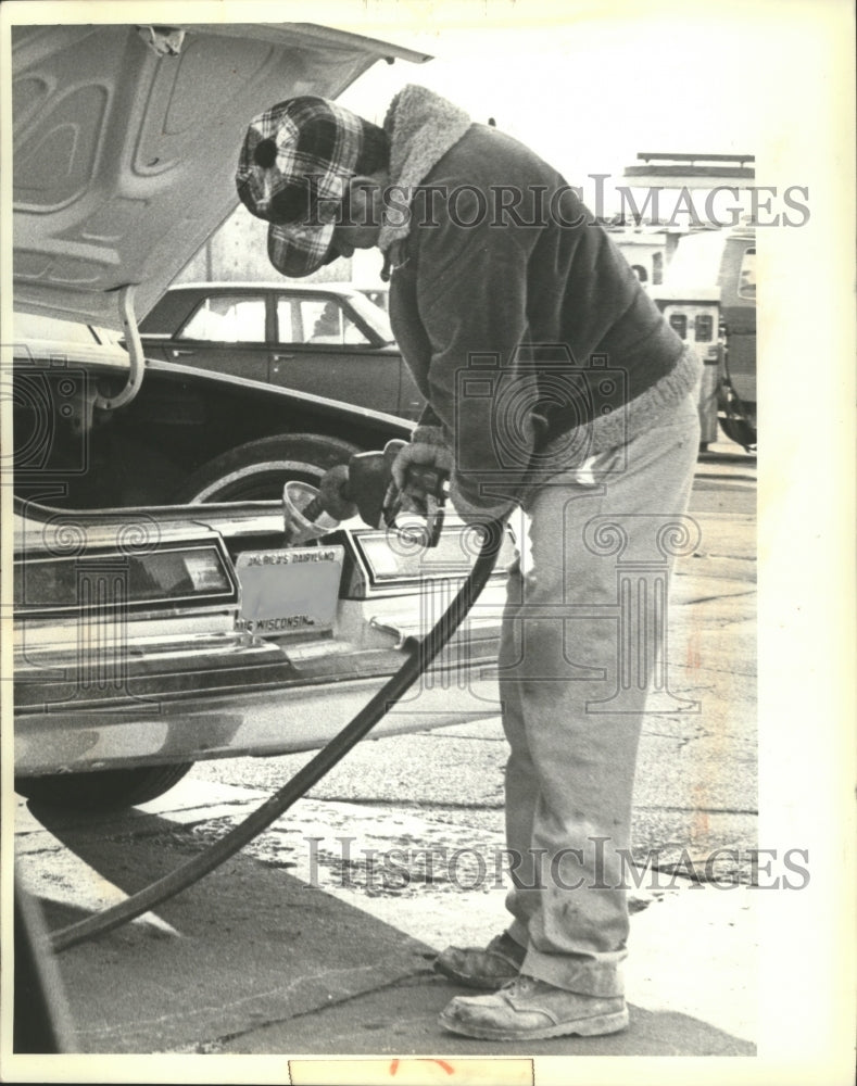 1980 Press Photo Man Violates Unleaded Gas Law at Madison, Wisconsin Gas Station - Historic Images