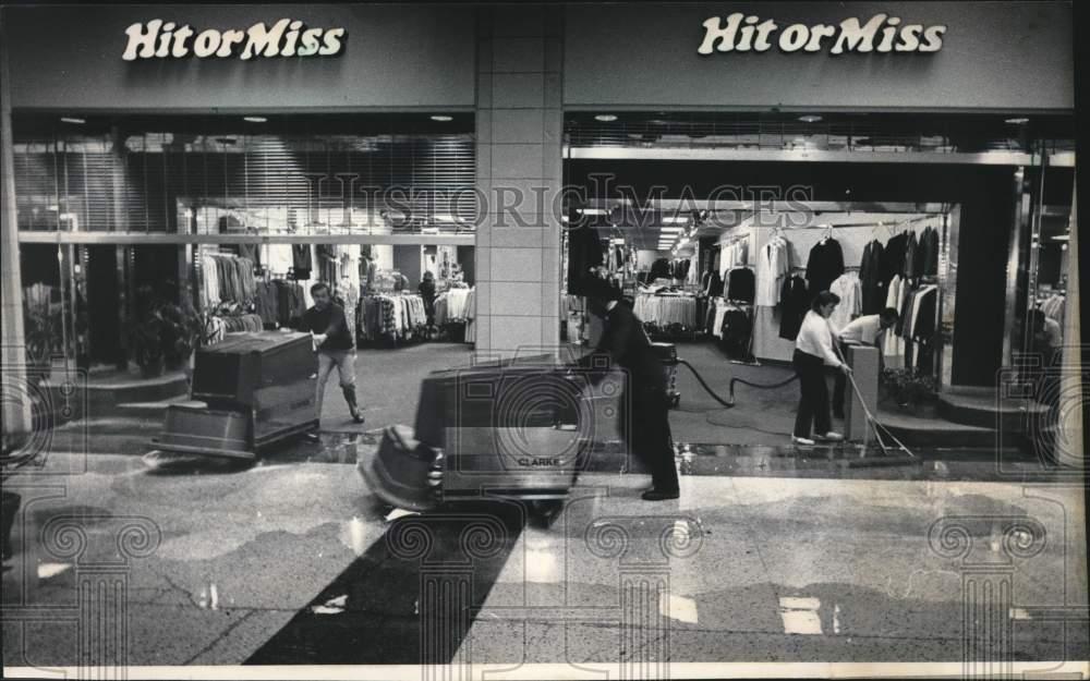 1985 Press Photo Workers use water vacuums after pipe break at Grand Avenue Mall - Historic Images