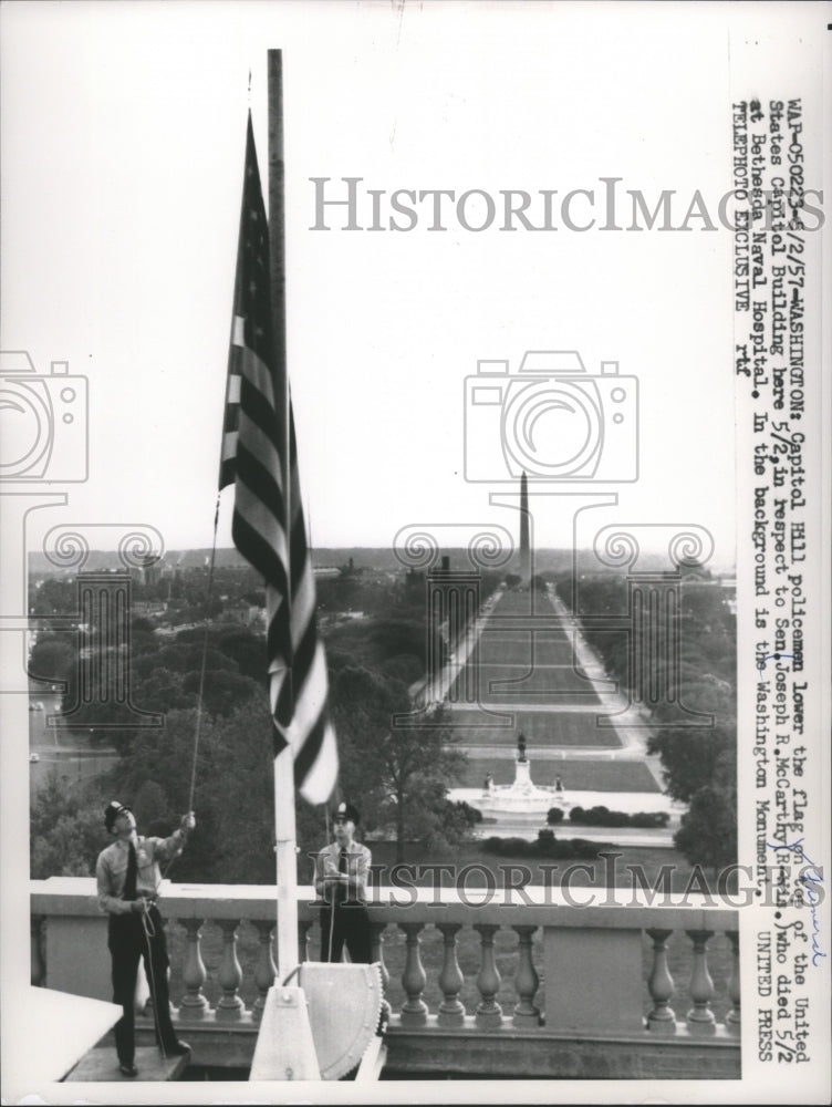 1957 Press Photo Policemen Lower Flag on United States Capitol Building - Historic Images