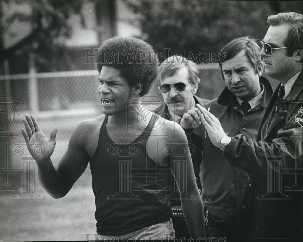 1979 Press Photo Senior is Escorted From Confrontation At Madison High School - Historic Images