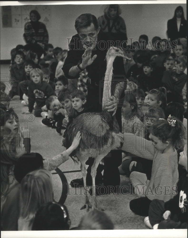 1993 Press Photo Young students watch ostrich walk among them - mjb26868 - Historic Images