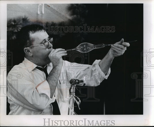 Using centuries old process begins to form glass into a swan-Historic Images