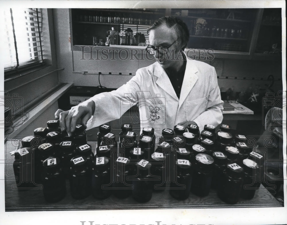 Brian Unsworth with bottles of defective mouse fetuses, Marquette-Historic Images