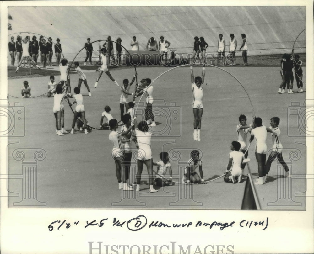 1983 Press Photo Swiss Gymnastics team uses large hoops during performance - Historic Images