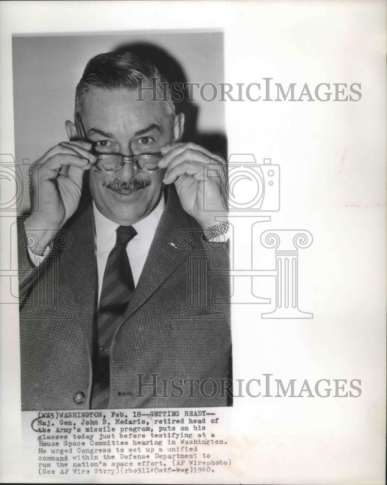 1960 Press Photo Major General John Medaris, putting on glasses, Washington D.C.-Historic Images