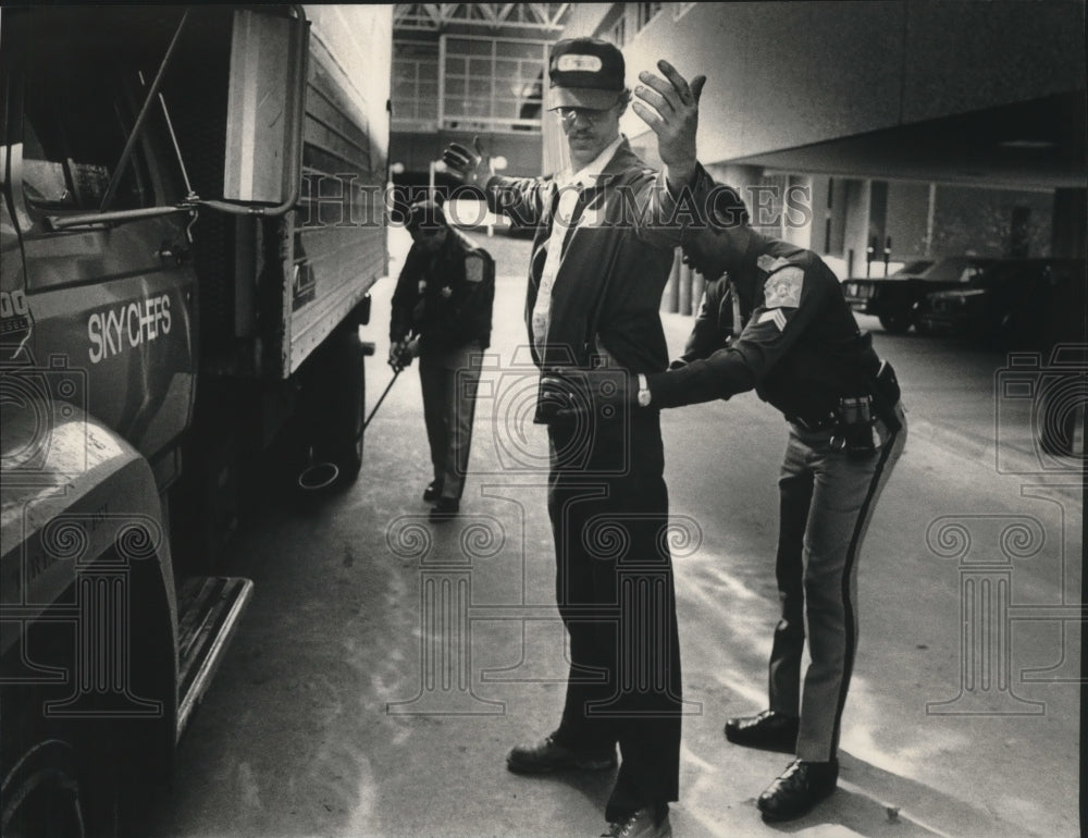 1991 Press Photo Ron Murphy is searched at Milwaukee&#39;s Mitchell Airport - Historic Images