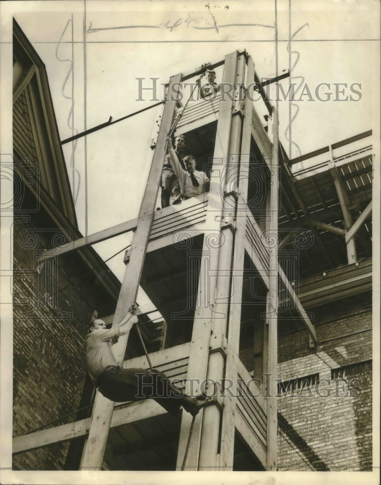 1964 Press Photo Milwaukee Firefighter Walter Augat gives a demonstration-Historic Images