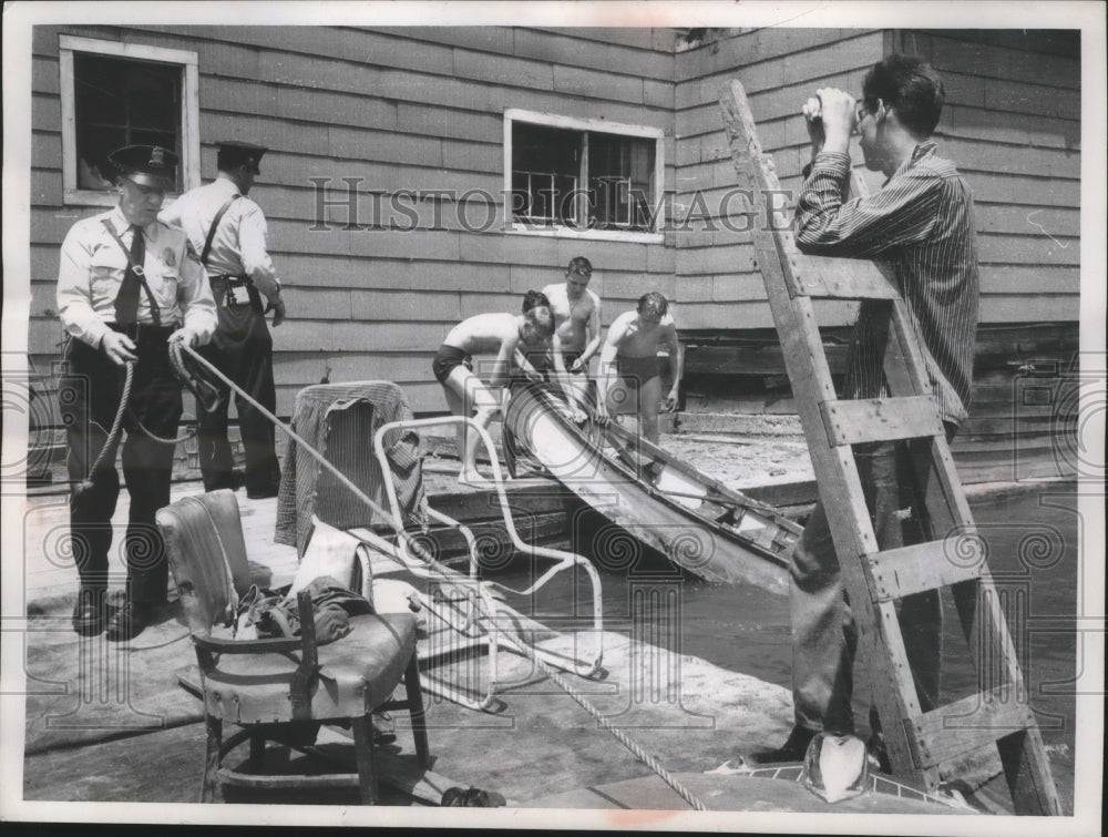 1957 Milwaukee Police officers have boys haul their boat from river-Historic Images