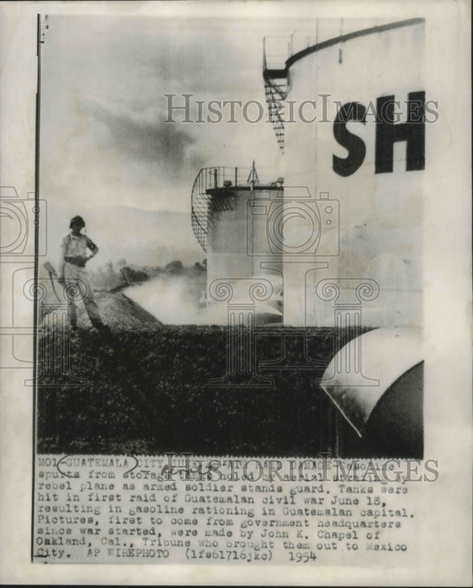 1954 Guard stands by gasoline tanks hit from a raid, Guatemala City.-Historic Images