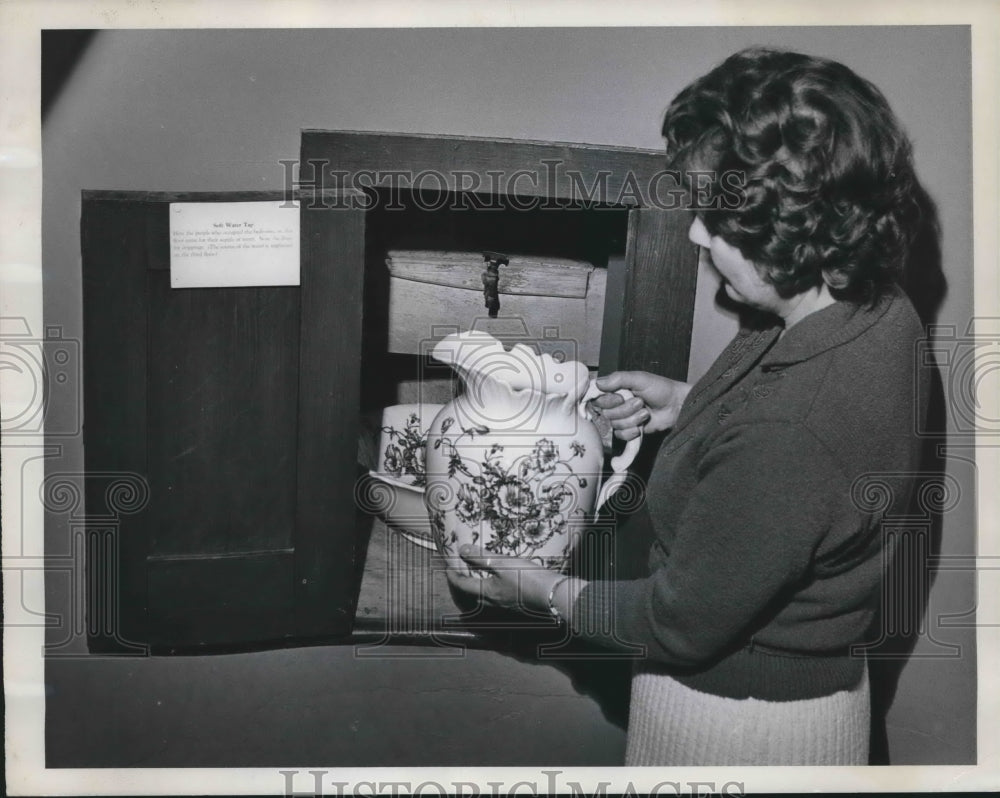 1963 Mrs. Mabie custodian, demonstrates water tap in room, Wisconsin - Historic Images