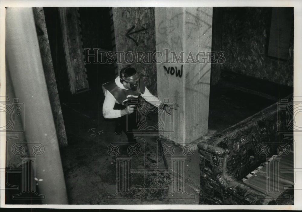 1989 A participant creeps through the combat zone at Paintball Daves Historic Images
