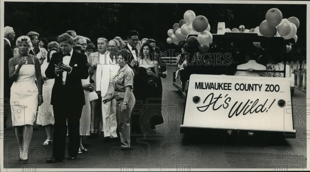 1989 Guests carried Zoo Ball carried in zoomobiles, Milwaukee Zoo - Historic Images