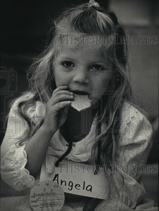 1987  Angela Cosme enjoys first break at kindergarten, Milwaukee - Historic Images