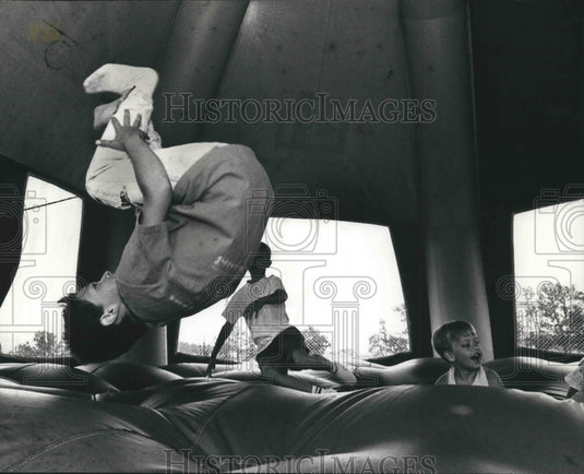 1992 Children playing moonwalk tent at Meadowview School Oak Creek. - Historic Images