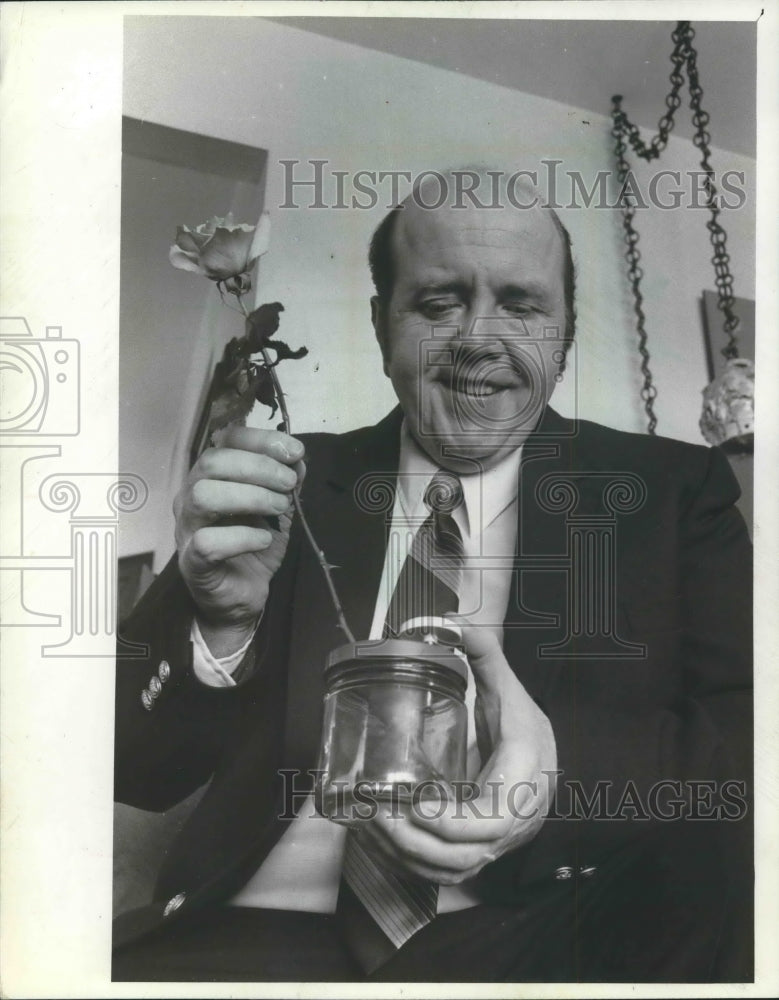 1982 Allan Hauser, Milwaukee, holding new invention, a flower cutter - Historic Images