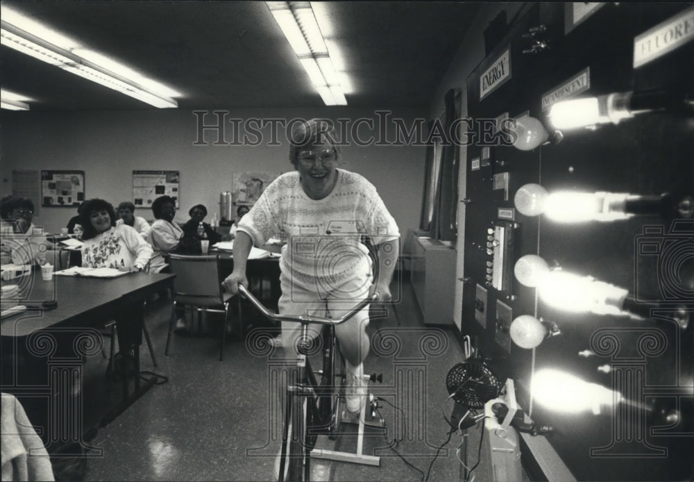 1983 Lillian Weigh pedals bike that makes electricity, Milwaukee - Historic Images