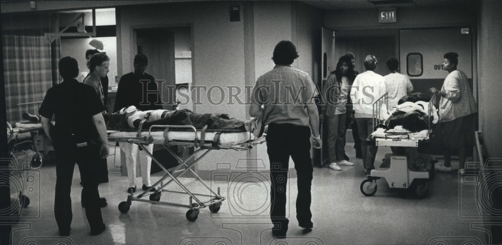 1989 Emergency patients wheeled into Milwaukee Co. Medical Complex - Historic Images