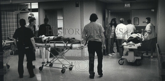1989 Emergency patients wheeled into Milwaukee Co. Medical Complex - Historic Images