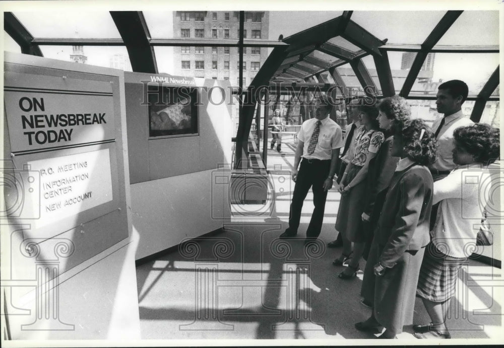 1983 Northwestern Mutual Life, Milwaukee,  employees watch news show-Historic Images