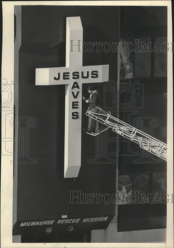 1985 A worker repairs cross at Milwaukee Rescue Mission-Historic Images