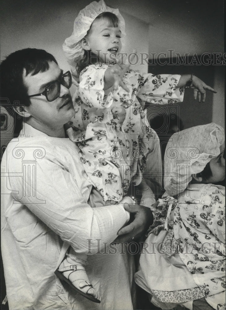 1983 Dennis Behr holds daughter at Good Samaritan Medical Center - Historic Images