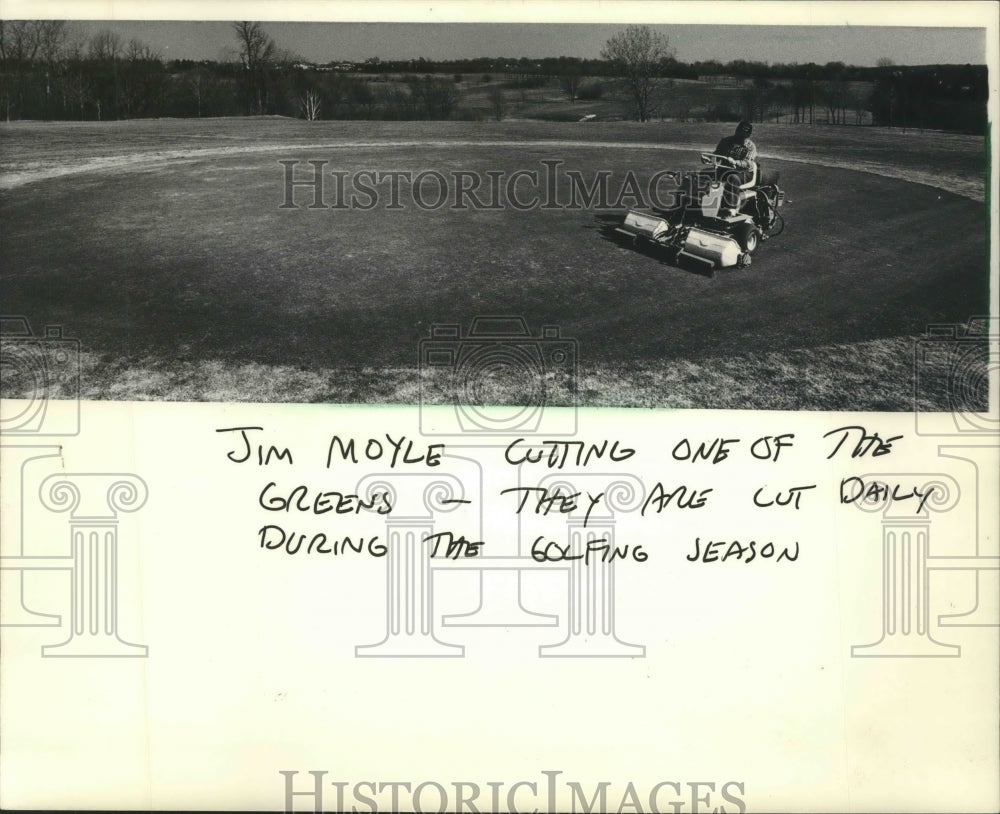 1986 Jim Moyle, parks employee at Dretzka Golf Course, cuts green.-Historic Images