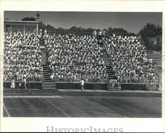 1987 Students of Oconomowoc , WI, High School sitting in bleachers - Historic Images