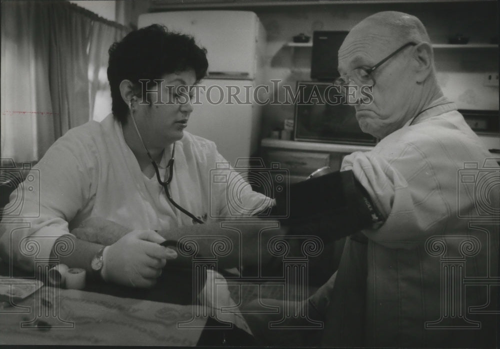 1983 Milwaukee Nurse Margaret Driss using blood pressure equieupment - Historic Images