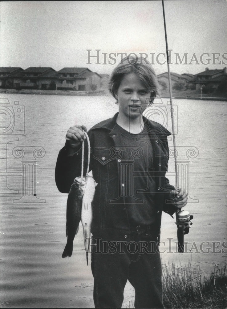 1979 Young fisherman and his catch at Northridge Lake - Historic Images
