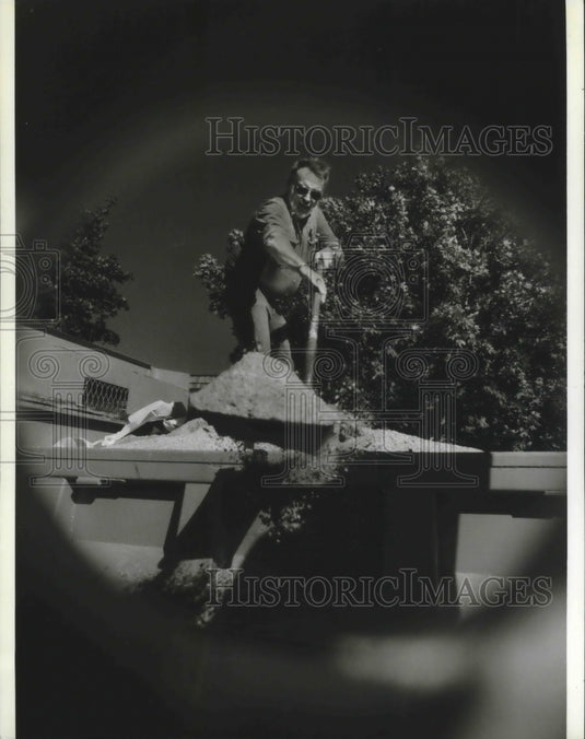 1994 Jim Parish fills drums with sand and salt for winter, Wauwatosa - Historic Images