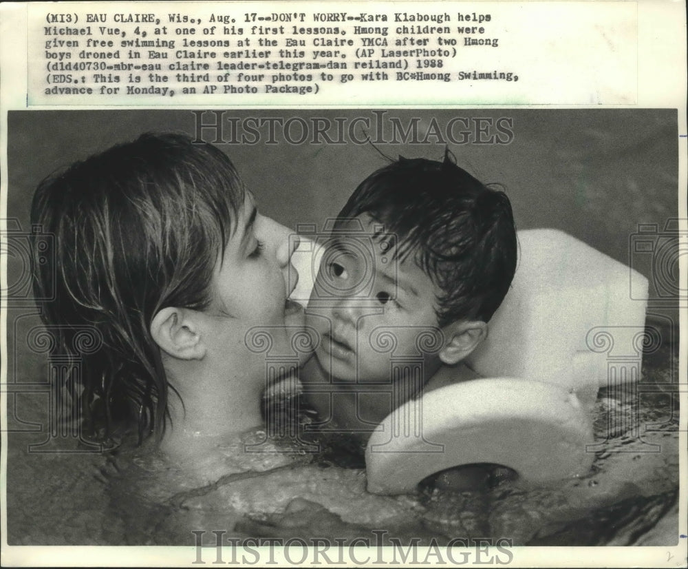 1988 Kara Klabough holding Michael Vue during lessons, Wisconsin. - Historic Images