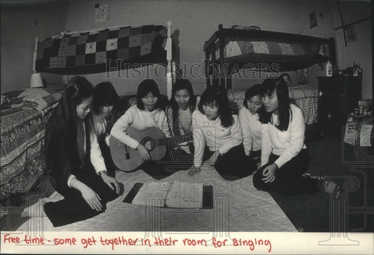 1986 Girls sing in one of the rooms that are home for six girls each - Historic Images
