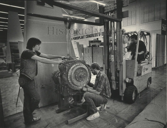1985 Workmen remove automotive show display at MECCA, Milwaukee - Historic Images