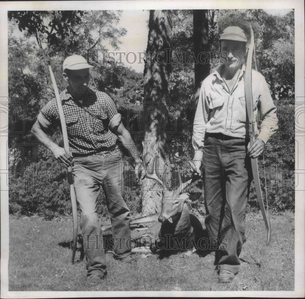 1954 Press Photo Hunters Ernie Parish and Robert Shepherd drag buck Wisconsin - Historic Images