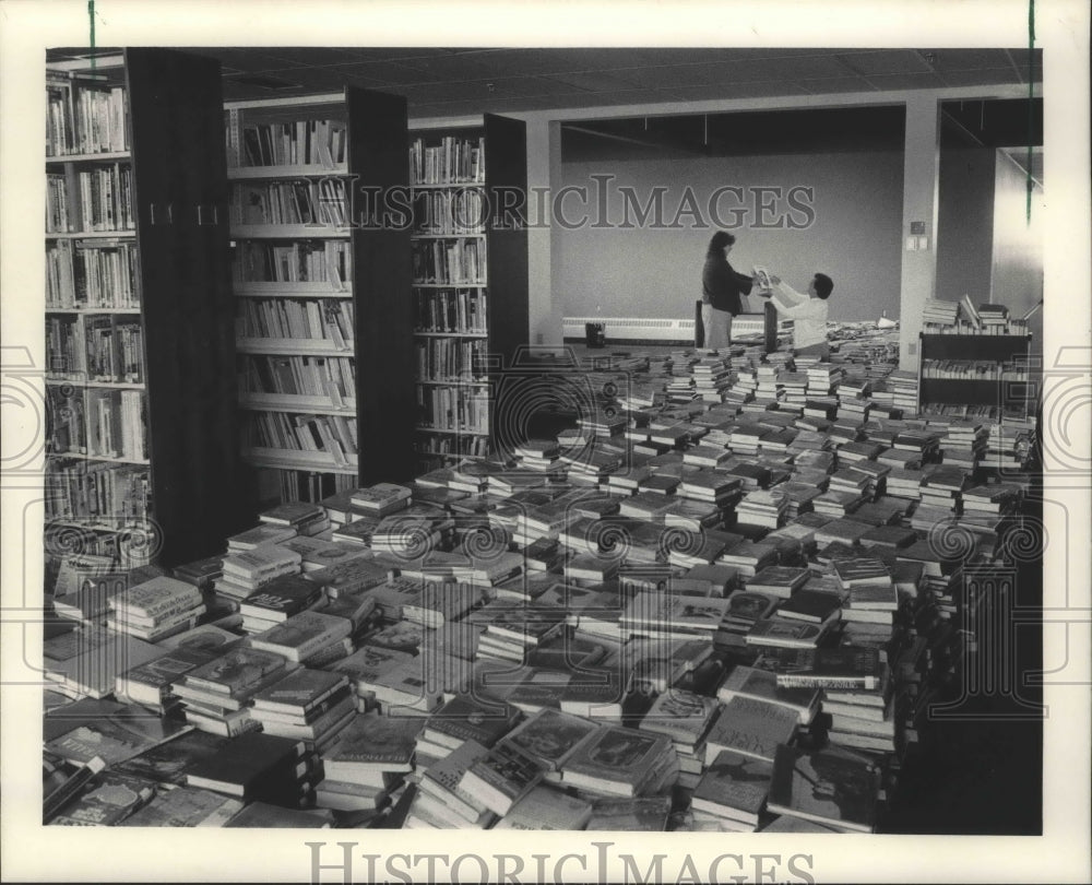 1983 New Berlin Public library employees sort books on floor-Historic Images