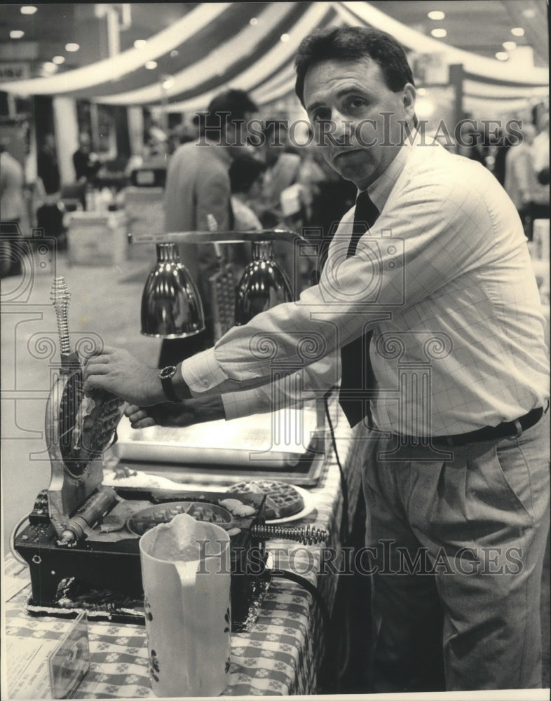 1987 Paul Gursen, pulls waffle from iron at trade show, Milwaukee.-Historic Images