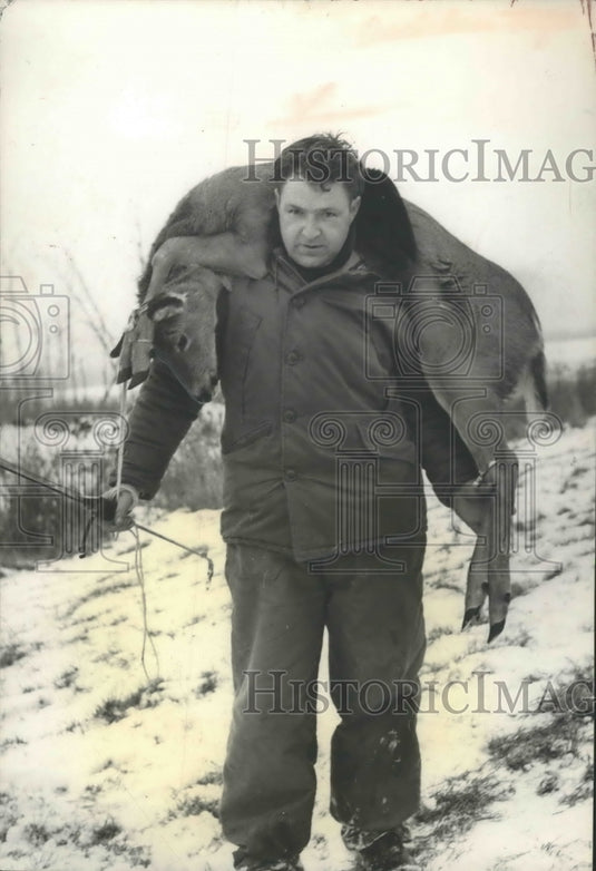Deer Hunter carrying a deer-Historic Images